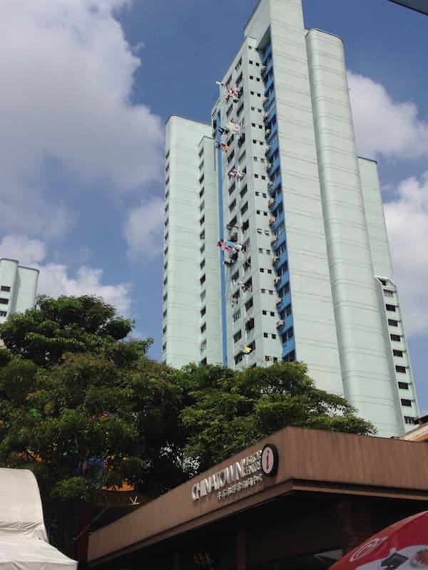 The clothes hanging out of apartment in China town in Singapore